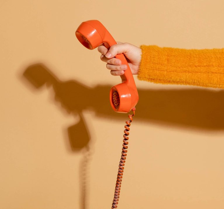 woman-answering-corded-retro-phone
